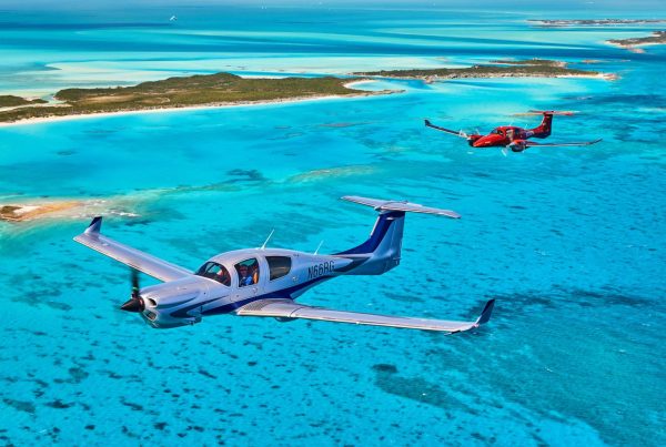 Diamond Aircraft planes flying over turquoise Caribbean waters showcasing luxury aviation