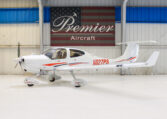 White single-engine light aircraft N627PS in Premier Aircraft hangar, side view with T-tail and propeller, for sale
