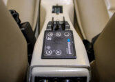 Diamond Aircraft cockpit center console with climate control panel, power switches, and beige leather seats.
