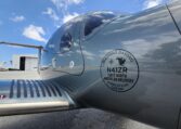 Diamond DA50 RG N41ZR first North American delivery badge on fuselage at airport ramp under blue sky