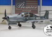 Diamond DA50 RG N41ZR in Premier Aircraft hangar, sleek gray single-engine prop plane, first North American delivery.