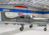 Gray Diamond Aircraft single-engine prop plane N41ZR parked in a bright Premier hangar.