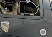 Diamond Aircraft airplane door close-up showing vent window, latch handle, and gray fuselage detail