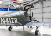 Single-engine piston airplane in hangar with gullwing doors open, N41ZR tail number visible, ready for private flight.