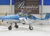 Blue Diamond DA62 twin-engine propeller airplane in hangar at Premier Aircraft, front three-quarter view
