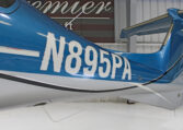 Blue airplane tail number N895PA in hangar, close-up of private aircraft registration.