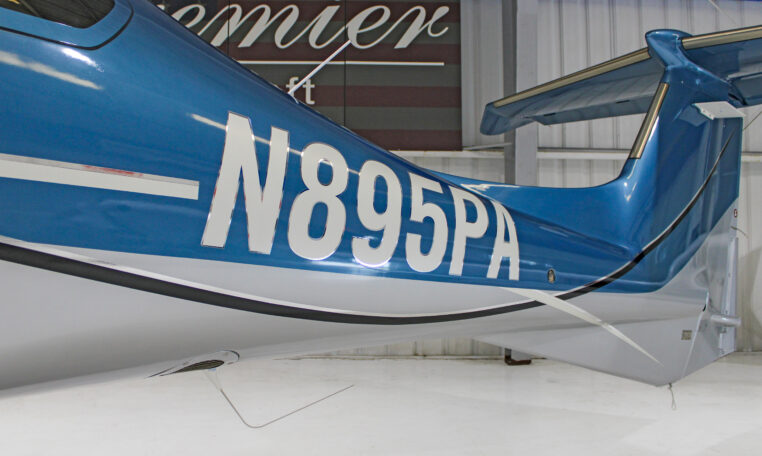 Blue airplane tail number N895PA in hangar, close-up of private aircraft registration.