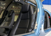 Luxury helicopter interior with black leather seats and open door, showing cockpit armrest and modern trim.