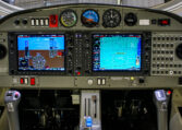 Airplane cockpit panel with dual glass avionics displays, flight instruments, GPS map and controls in a light aircraft
