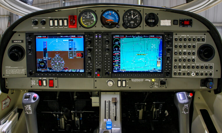 Airplane cockpit panel with dual glass avionics displays, flight instruments, GPS map and controls in a light aircraft