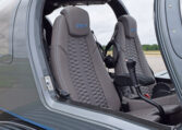 Diamond DA50 RG aircraft cockpit with gray leather seats, honeycomb stitching, and side-stick controls on the tarmac.