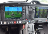 Modern airplane cockpit with Garmin glass cockpit avionics, dual displays, flight instruments and controls.