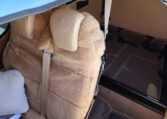 Diamond Aircraft interior with sheepskin rear seats and spacious luggage bay, beige upholstery and seatbelts.