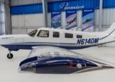 Piper Saratoga II TC N614DM single-engine aircraft in hangar at Premier Aircraft Sales