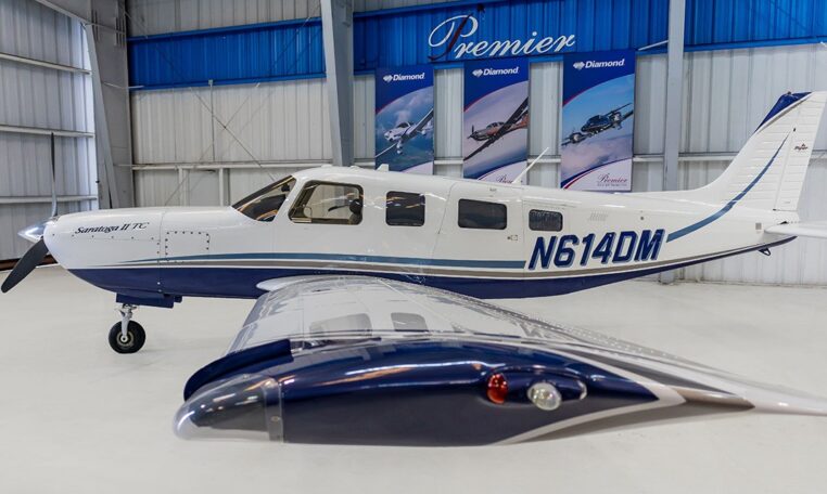 Piper Saratoga II TC N614DM single-engine aircraft in hangar at Premier Aircraft Sales