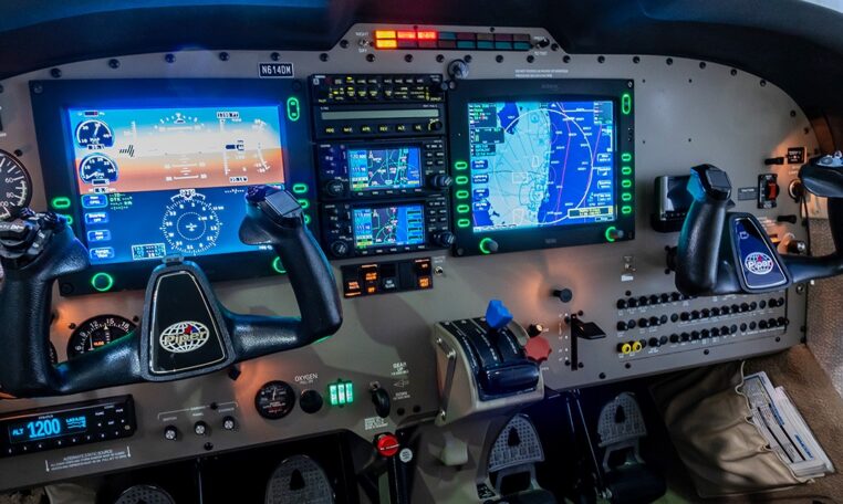 Modern Piper aircraft cockpit with dual yokes, Garmin glass avionics displays, GPS map and flight instruments.