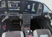 Cirrus SR22 airplane glass cockpit with dual Garmin Perspective displays, center keypad, side yokes, throttle quadrant.