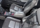 Cirrus aircraft cockpit interior with gray leather seats, 4-point harnesses, center console and avionics controls
