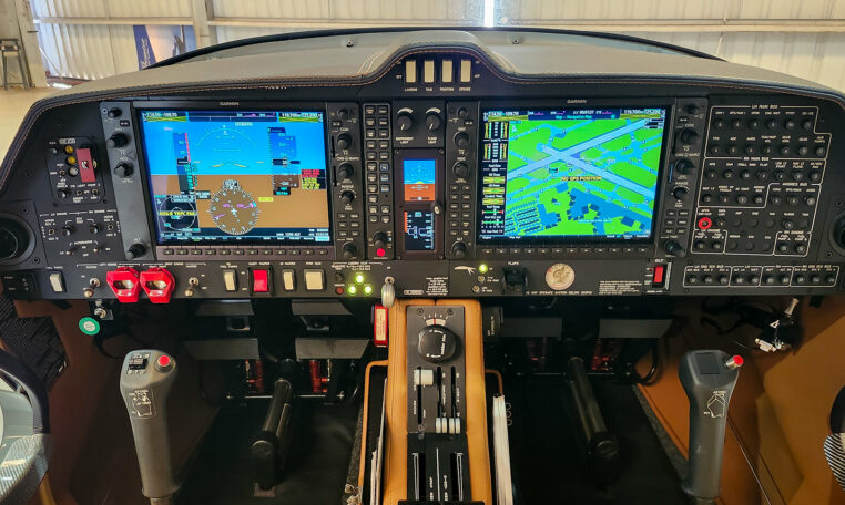 Modern light aircraft glass cockpit with dual Garmin G1000 displays, instrument panel and throttle quadrant.